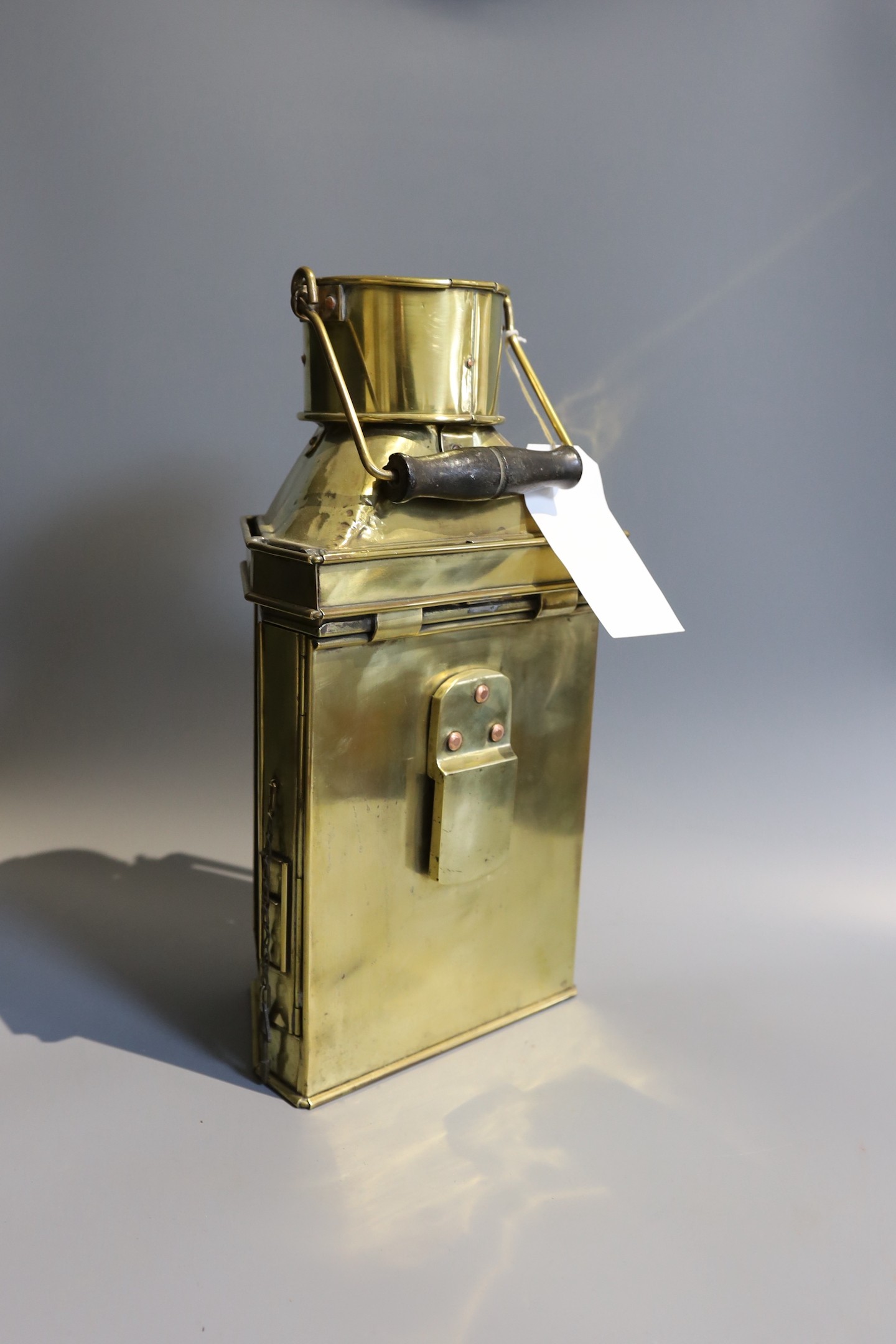 A Victorian brass carriage lamp, with turned wood handle, height 41cm, together with two other carriage lamps